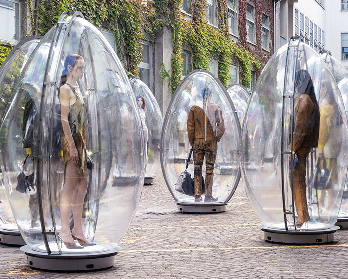 models encased in oversized transparent eggs pop up across milan for diesel's SS26 show